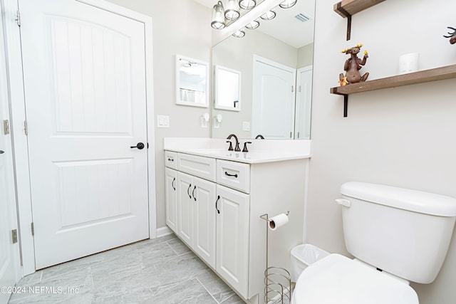 bathroom featuring vanity and toilet