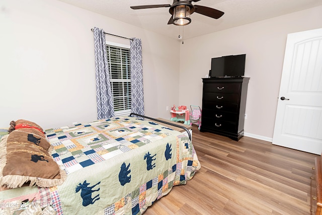 bedroom featuring hardwood / wood-style floors and ceiling fan