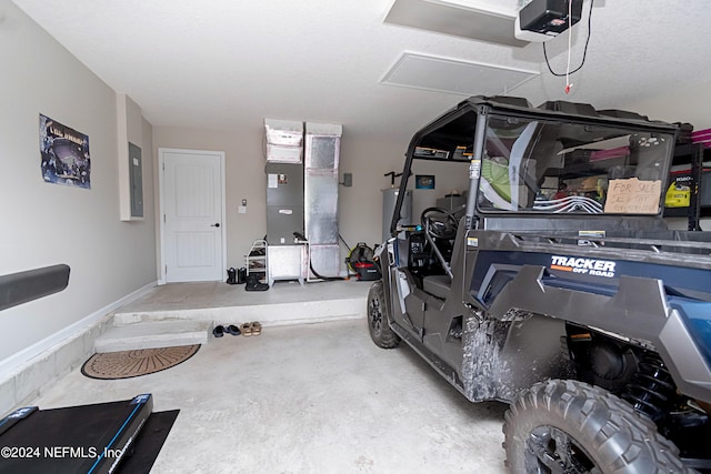 garage with a garage door opener and electric panel