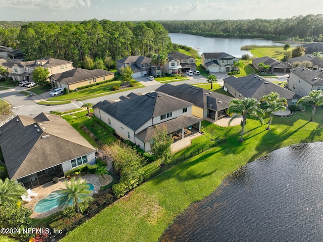 aerial view featuring a residential view, a water view, and a view of trees