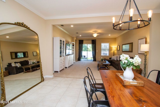 tiled dining space with ceiling fan with notable chandelier and crown molding