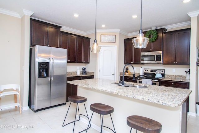 kitchen featuring sink, hanging light fixtures, a kitchen island with sink, and stainless steel appliances