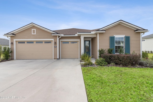 view of front of house with a garage and a front yard