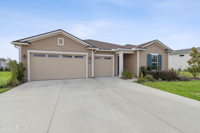 ranch-style home featuring an attached garage and driveway