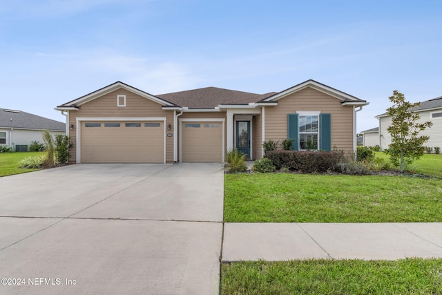 ranch-style home featuring driveway, a front lawn, and a garage