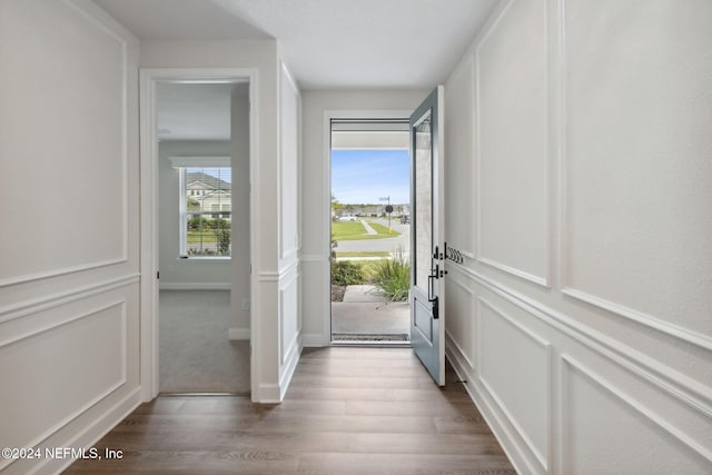 doorway to outside featuring a decorative wall and dark wood-type flooring