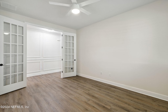 spare room featuring french doors, hardwood / wood-style floors, and ceiling fan