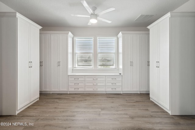 bonus room featuring a textured ceiling, light wood-type flooring, and ceiling fan