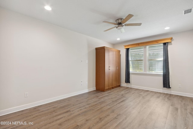 unfurnished bedroom featuring baseboards, light wood-style floors, visible vents, and recessed lighting