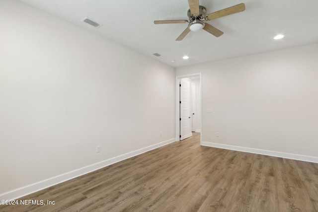 spare room with a ceiling fan, wood finished floors, baseboards, visible vents, and recessed lighting