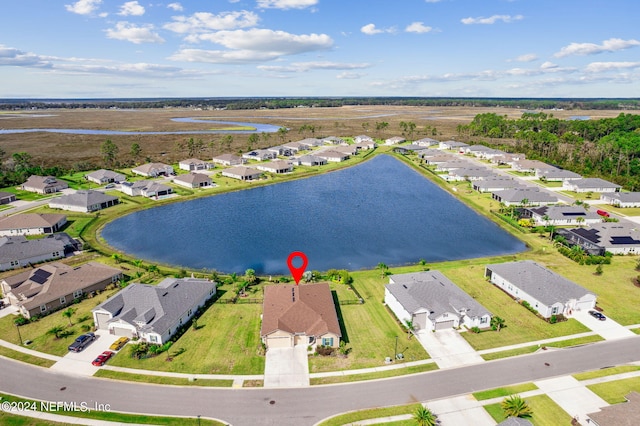 drone / aerial view featuring a residential view and a water view