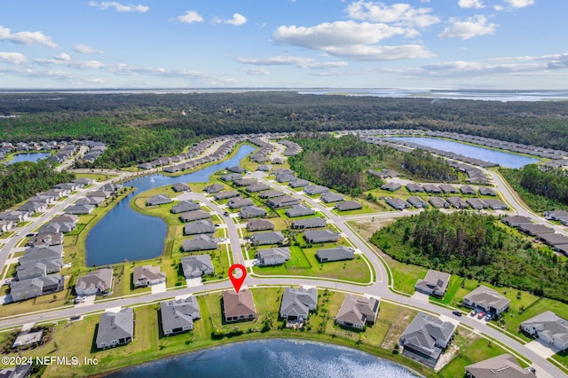 birds eye view of property featuring a residential view, a wooded view, and a water view