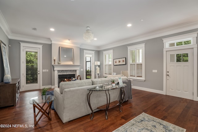 living room with a fireplace, crown molding, and dark hardwood / wood-style flooring