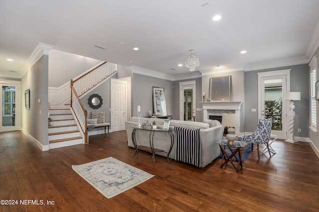 living room with ornamental molding, dark hardwood / wood-style floors, and a premium fireplace