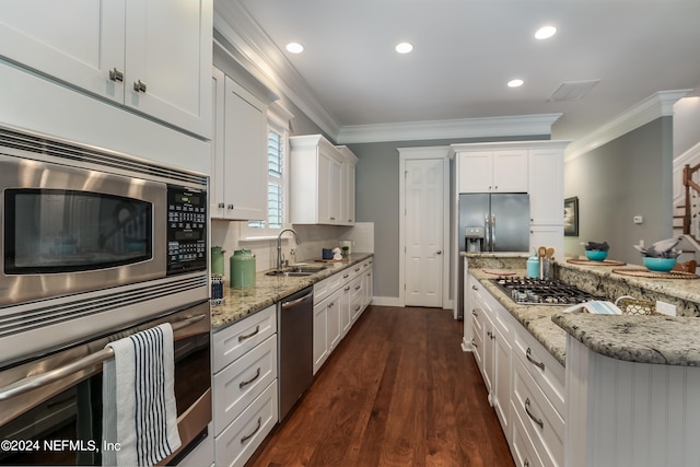 kitchen featuring crown molding, dark wood-type flooring, sink, stainless steel appliances, and white cabinetry