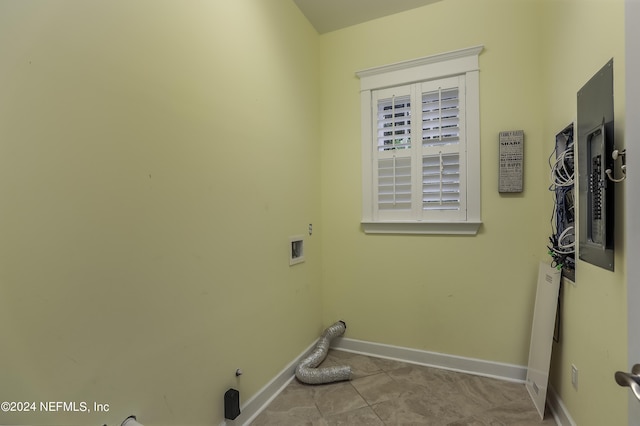 clothes washing area with hookup for a washing machine, gas dryer hookup, and light tile patterned floors