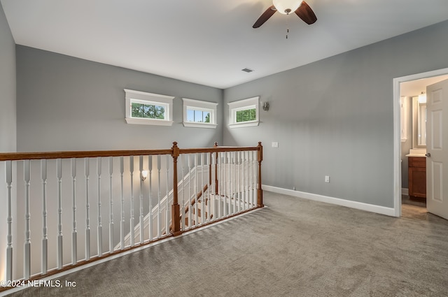 hallway featuring light colored carpet