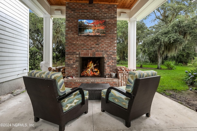 view of patio featuring an outdoor living space with a fireplace