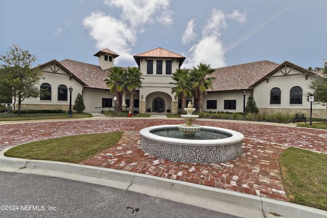 mediterranean / spanish-style house featuring a front lawn