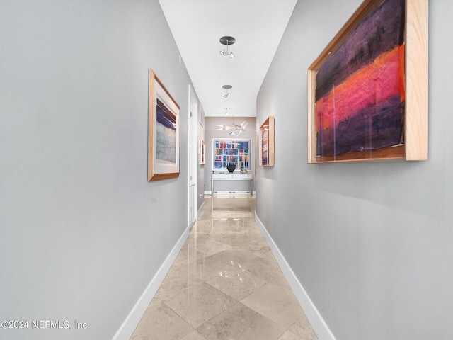 hallway featuring a chandelier