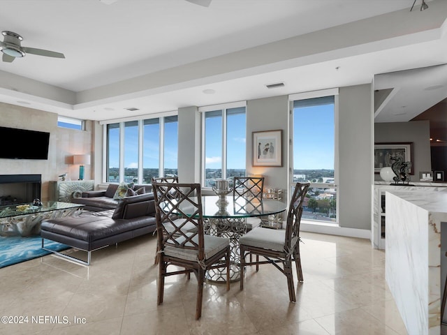 dining room with ceiling fan and expansive windows