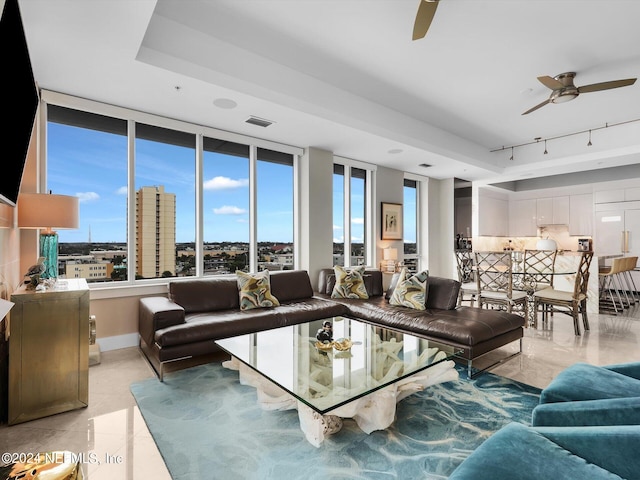 living room featuring light tile patterned floors and ceiling fan