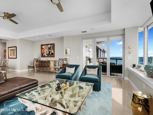 living room featuring a water view and ceiling fan