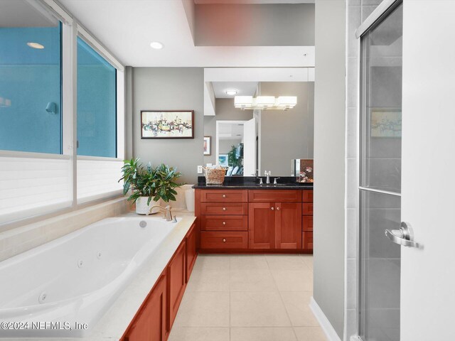 bathroom featuring vanity, shower with separate bathtub, and tile patterned flooring