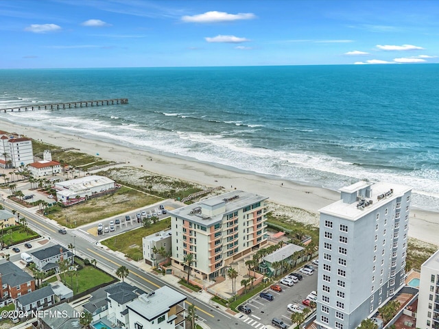 birds eye view of property with a beach view and a water view