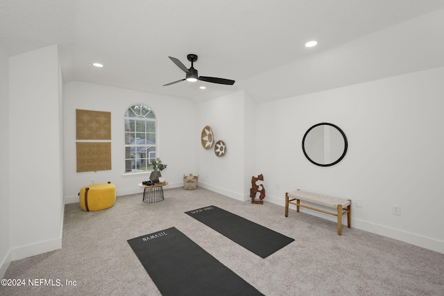 workout room with carpet flooring, vaulted ceiling, and ceiling fan