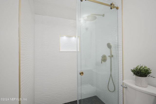 bathroom featuring toilet and walk in shower