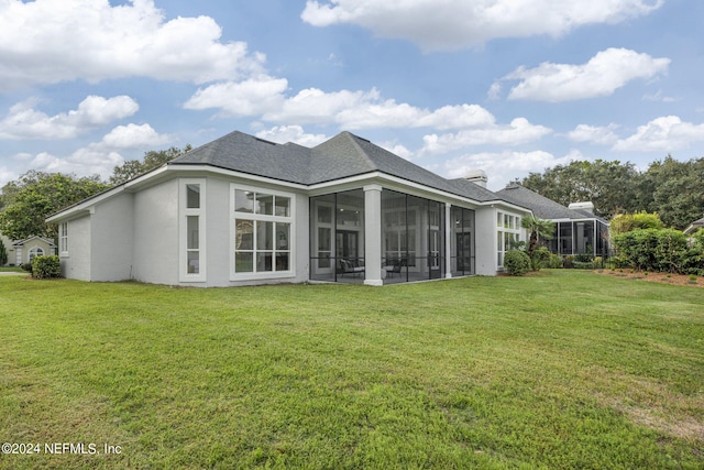 back of property featuring a yard and a sunroom