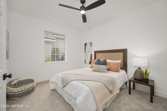 bedroom featuring light carpet and ceiling fan