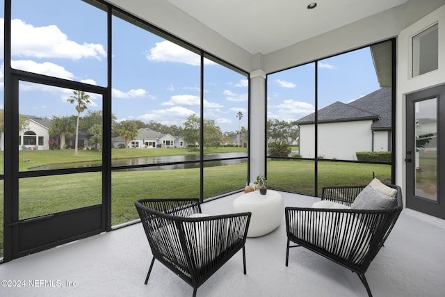 sunroom with a water view and plenty of natural light