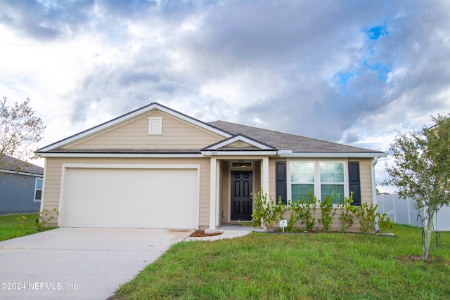 view of front of house with a garage and a front lawn