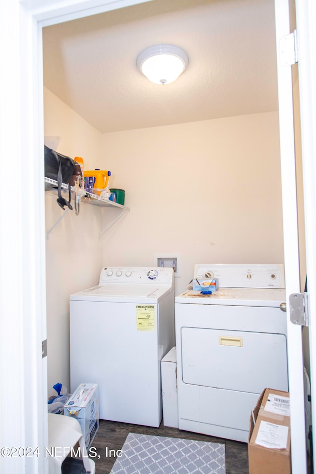 laundry area with washing machine and dryer and dark hardwood / wood-style floors