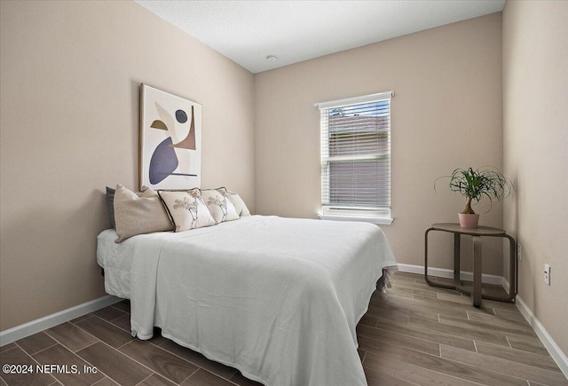 bedroom featuring dark hardwood / wood-style flooring