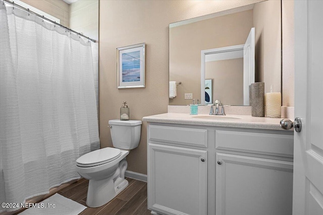 bathroom featuring vanity, toilet, and wood-type flooring