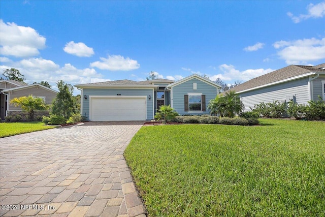 ranch-style home with a garage and a front lawn