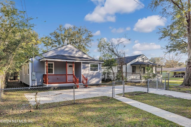 bungalow featuring a porch and a front lawn