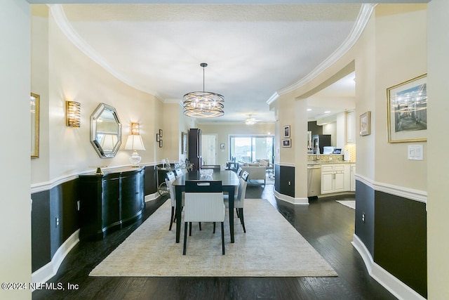 dining area with an inviting chandelier, ornamental molding, and dark wood-type flooring