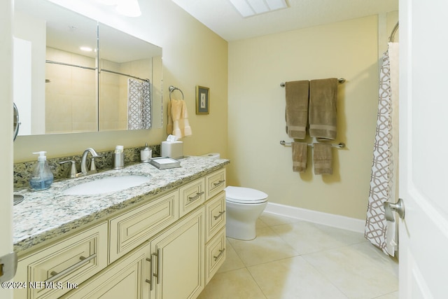 bathroom with vanity, toilet, a shower with curtain, and tile patterned flooring