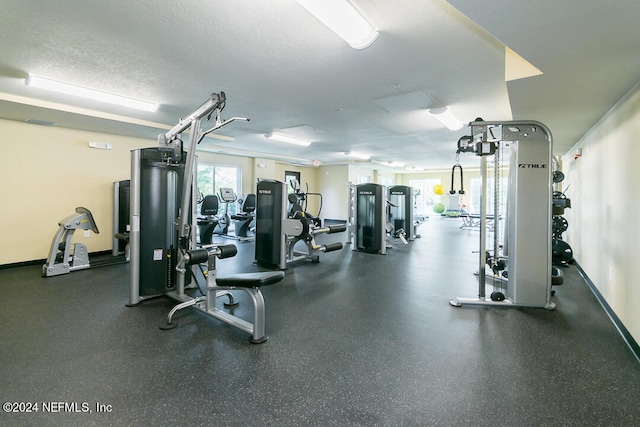 gym featuring a textured ceiling