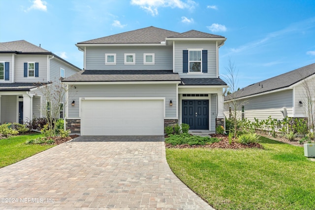 view of front of house with a front yard and a garage