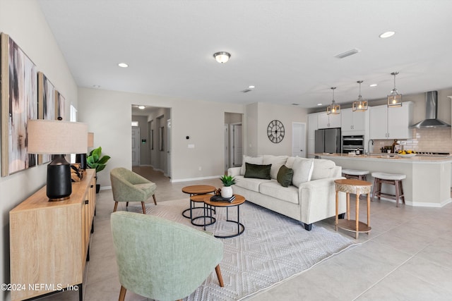 tiled living room featuring sink