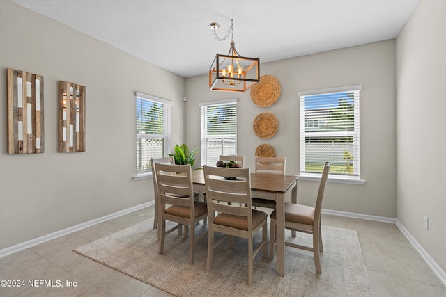 dining space with light tile patterned flooring, an inviting chandelier, and a healthy amount of sunlight