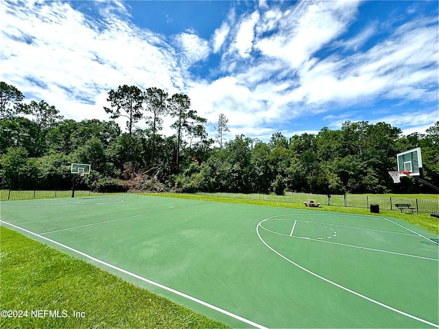 view of basketball court featuring a yard