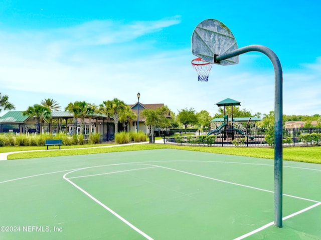 view of basketball court with a playground