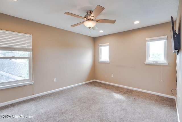 spare room featuring ceiling fan, plenty of natural light, and carpet