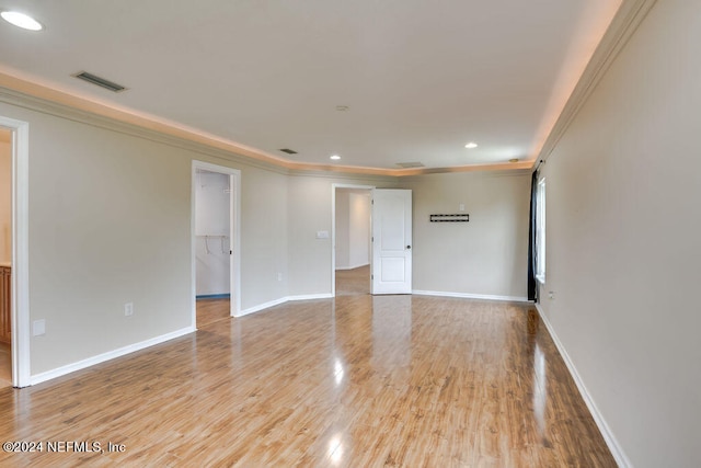 unfurnished room with light hardwood / wood-style flooring and ornamental molding